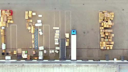 Aerial top down view of the big logistics park with warehouses, loading hub and a lot of semi trucks