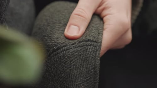 Creator Carefully Assesses Seams on Cozy Wool Hat in Studio Artisan Focuses on Tactile Quality of