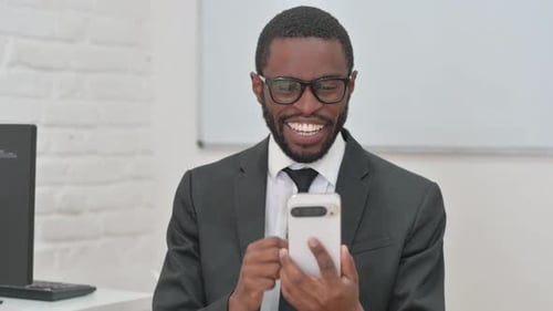 Man Celebrates Good News on His Mobile Phone