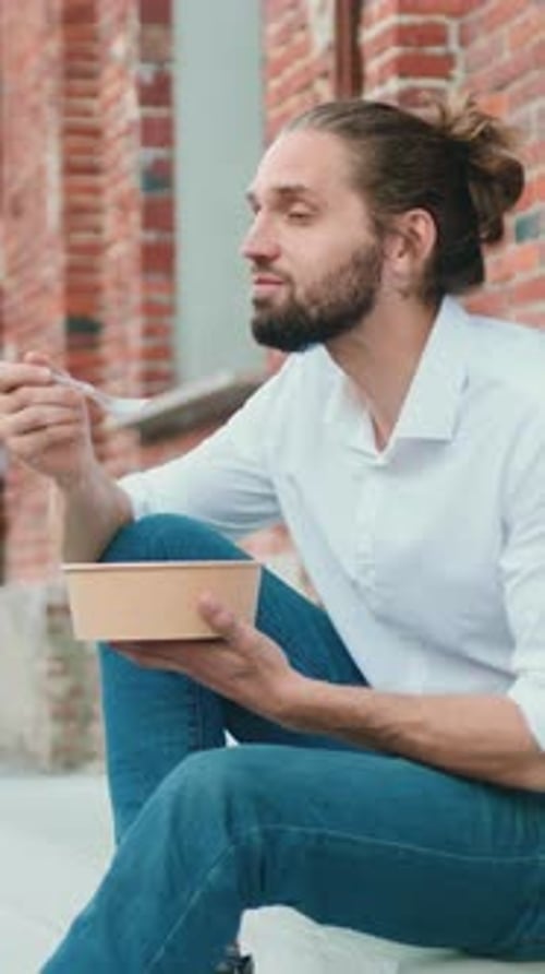 Man Eating Salad on Urban Steps During Lunch