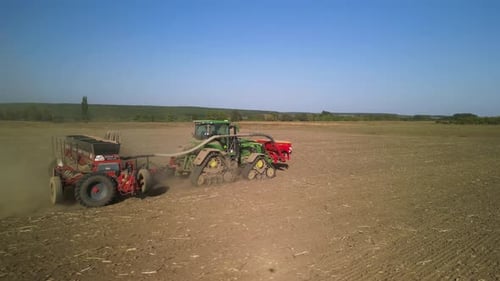 Tractor on the field seeding wheat