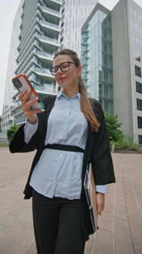 Businesswoman with Phone in Hand Goes to Courbevoie Paris