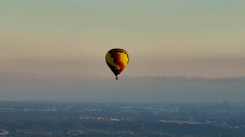 Air Balloon Flies Over City During Sunrise