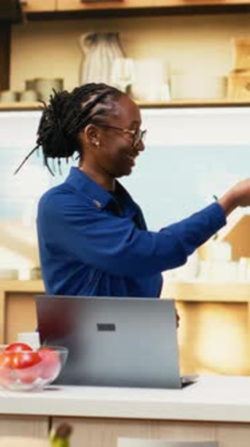 Enthusiastic Woman Talks in Kitchen Using Spaghetti Server