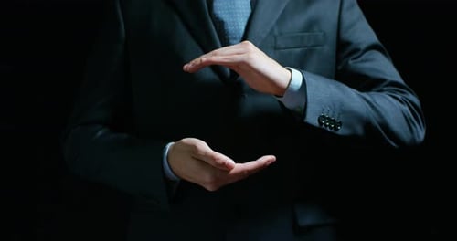Businessman Hands Presenting Invisible Object on Black