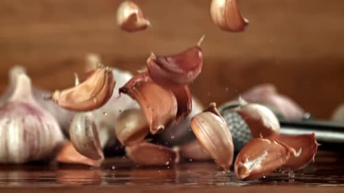 Garlic Falls on a Wooden Table Filmed on a Highspeed Camera at 1000 Fps