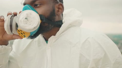 Man Puts On Full Face Respirator