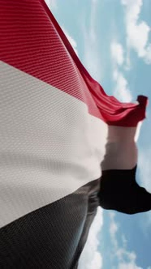 Yemen Flag Waving Against Blue Sky