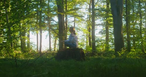 Woman Meditate Sitting in Dense Forest