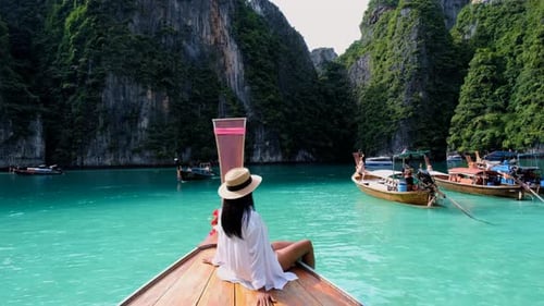 Women in Front of Longtail Boat at the Lagoon of Koh Phi Phi Thailand