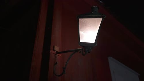 Old crooked street lamp in the dark. Creepy and isolated. Close up