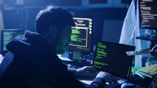 A Dedicated Cybersecurity Expert Works Late with Multiple Monitors Ensuring Digital Security