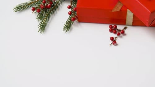 Festive Red Gift Boxes, Pine Cones, Berries on White