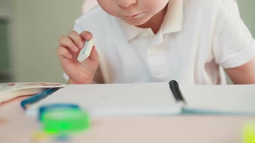 Child Learning to Write and Erase