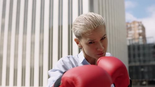Strong Woman with Boxing Gloves in City