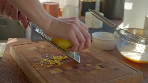 Zesting a Lemon on a Wooden Cutting Board