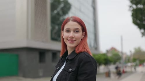 Happy Teenage Girl with Red Hair Posing Outside in the City
