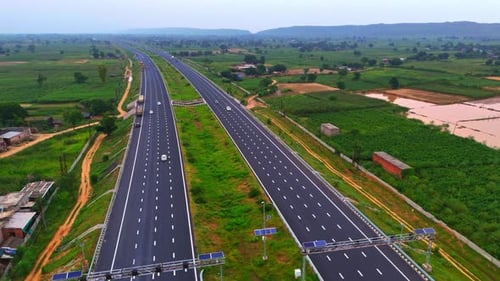 Modern roadways in Rajasthan wind through lush greenery, connecting villages and offering beautiful