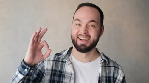 Man Giving Okay Sign and Smiling Happily