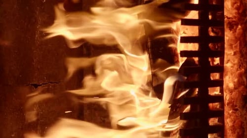 Intense Flames Dancing in Dark Fireplace Close-Up