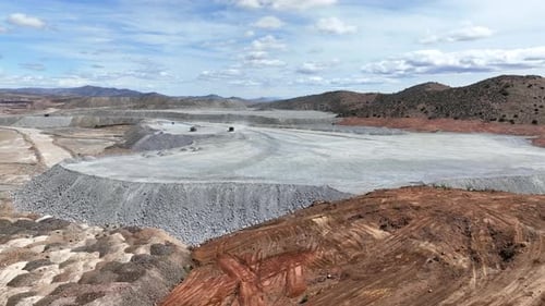 Aerial view of expansive copper mine in rugged terrain, United States.