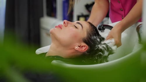 Woman Receiving Hair Wash at Salon, Spa Treatment
