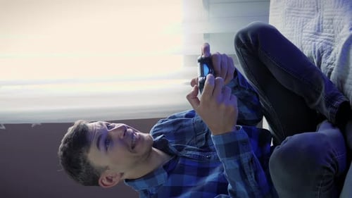 Man Plays Video Games Relaxing on the Couch