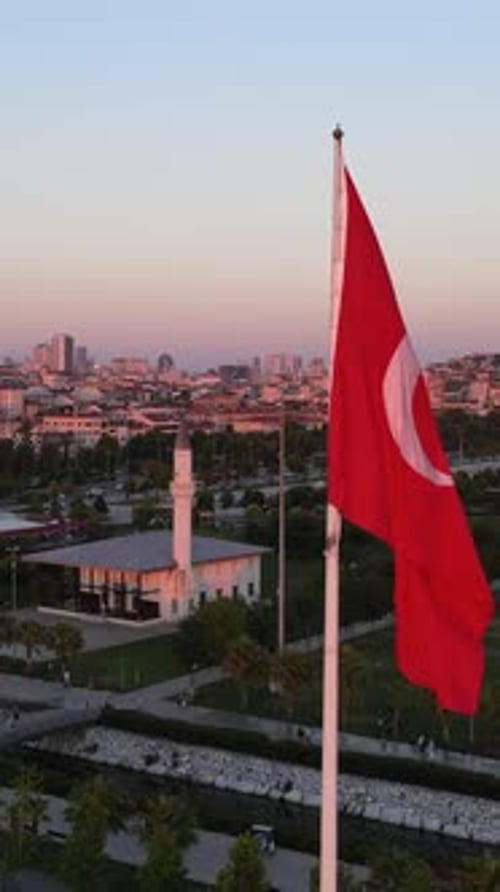 Turkish Flag Waving in Front of Cityscape at Sunset