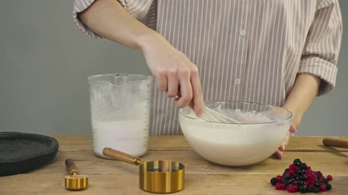 Preparing Pancake Batter in Kitchen with Whisk