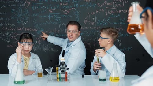 Students and Teacher Doing Science Experiment in Classroom