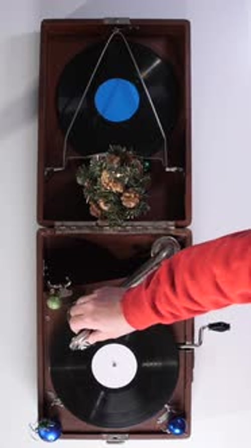 Hand Places Needle on Christmas Record Player