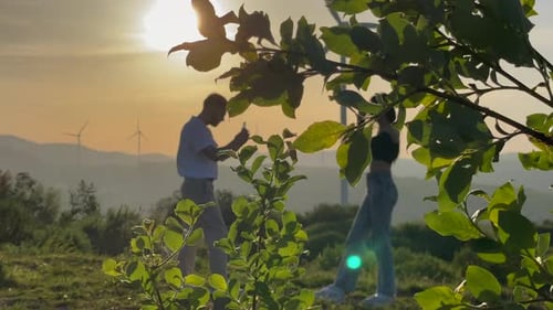 Young Couple in Rural Landscape at Sunset
