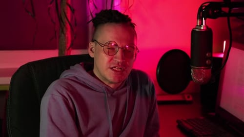 Young Adult Podcasting at Desk with Microphone
