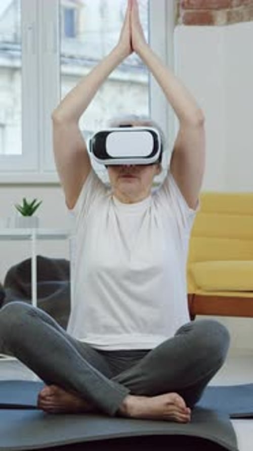 Senior Woman Meditating with VR Headset in Home