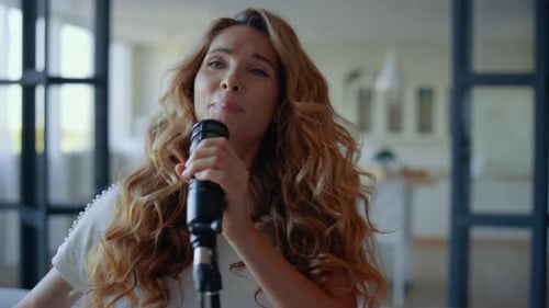 Woman Singing Passionately into Microphone at Home