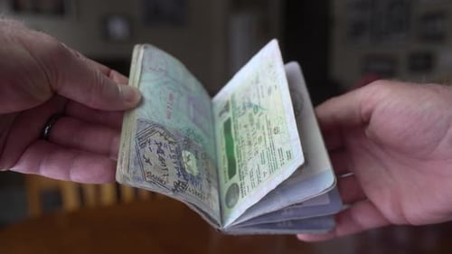 Well-Traveled Passport Open in Adult's Hands