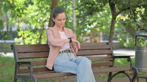 Waiting Young Woman Sitting in Park