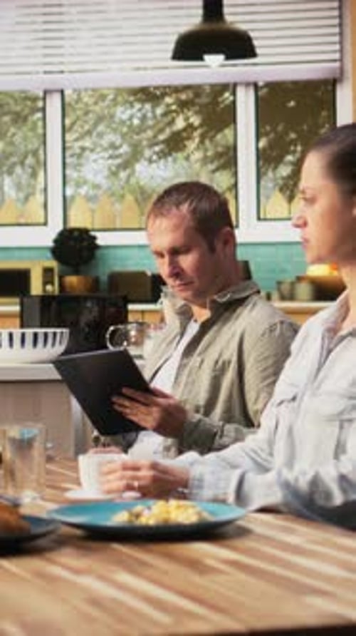 Vertical Video Working Dad on Tablet Ignoring Daughter and Family at Breakfast Table