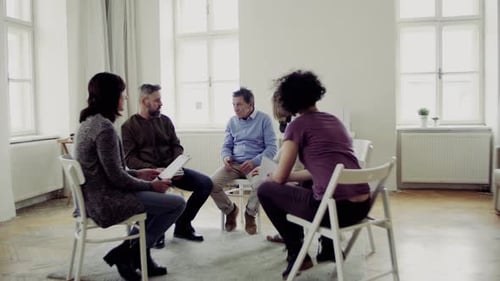 Adults Sitting in Circle During Group Discussion Indoors
