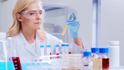 Scientist Handles Test Tubes in a Bright Laboratory