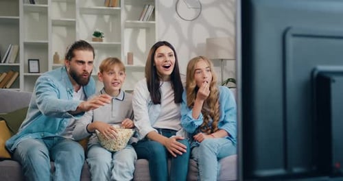 Family Watching TV Together in Living Room