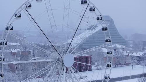 Ferris Wheel in a Snowy Cityscape Aerial View