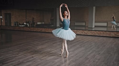 Ballerina Performing Elegant Ballet Dance in Studio