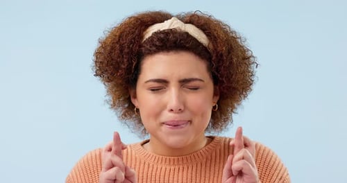 Hope, hands and woman with fingers crossed in studio for good luck, feedback