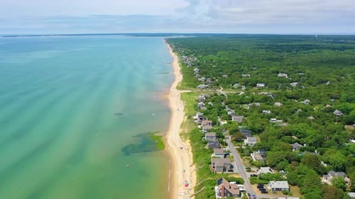 Drone Over Summer Beach with Families, Swimmers, and Coastal Homes
