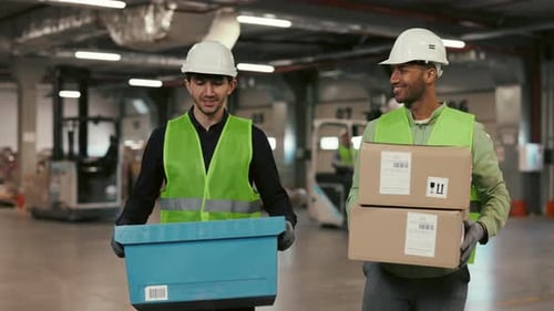 Warehouse Workers Carrying Boxes in Urban Factory