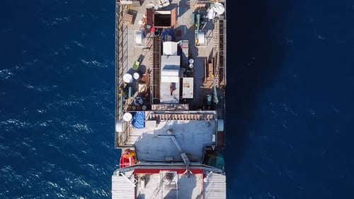 Aerial footage of a Medium size Livestock carrier cruising slowly