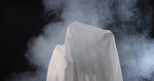 Spooky Figure Covered by Sheet Surrounded by Smoke