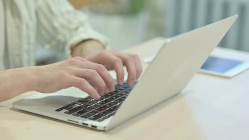 Close up of Male Hands Typing on Laptop