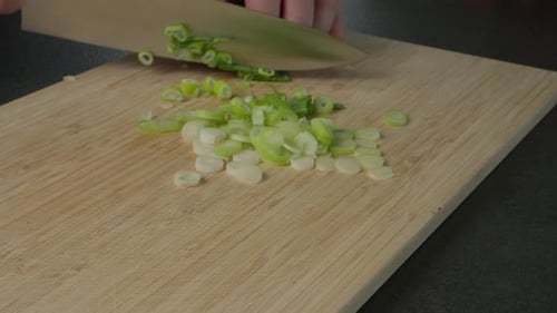 Chopping Green Onion on Wooden Cutting Board